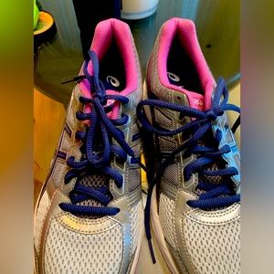 Silver and grey women’s ASICS athletic shoes